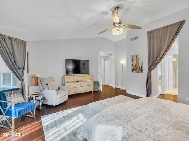 a bedroom with furniture and a chandelier