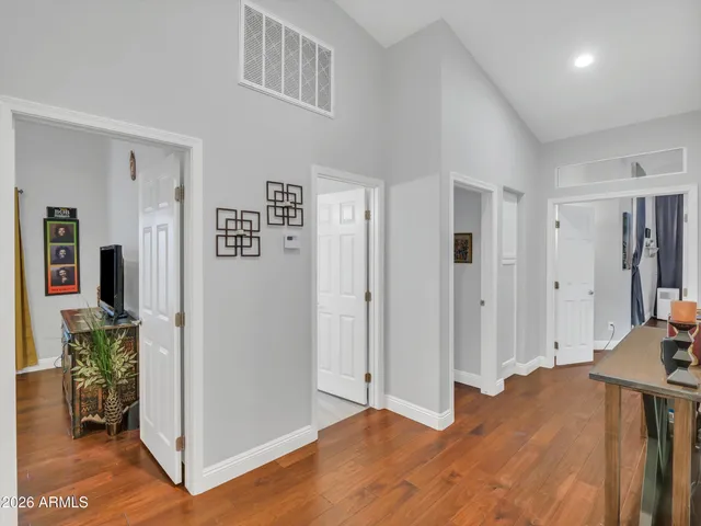 a view of a bedroom with wooden floor and a bedroom