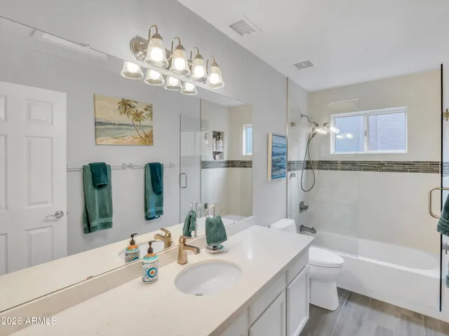 a bathroom with a sink a faucet a mirror and a bathtub with shower