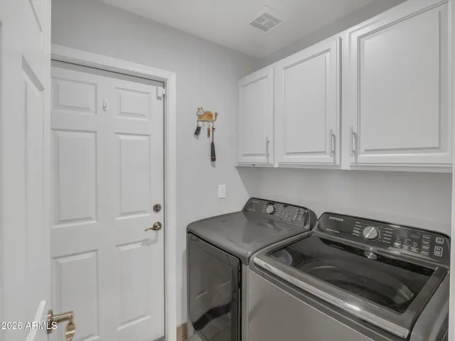 a kitchen with granite countertop white cabinets and black appliances