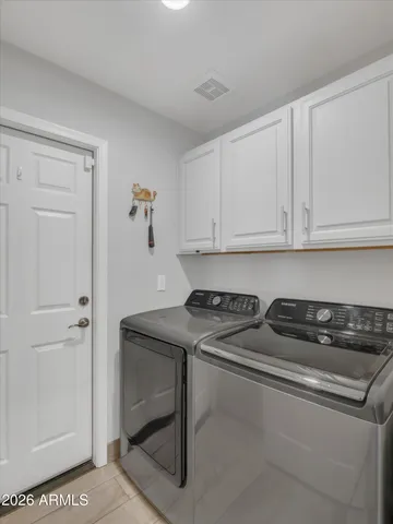 a view of a backyard with table and chairs and a large tree