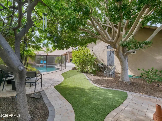 a view of a chair and table in the garden