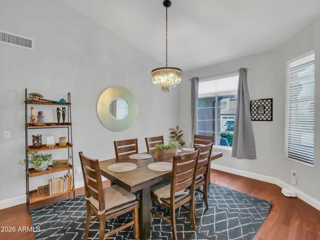 a dining room with furniture a rug and a window