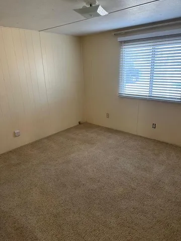an empty room with windows and closet