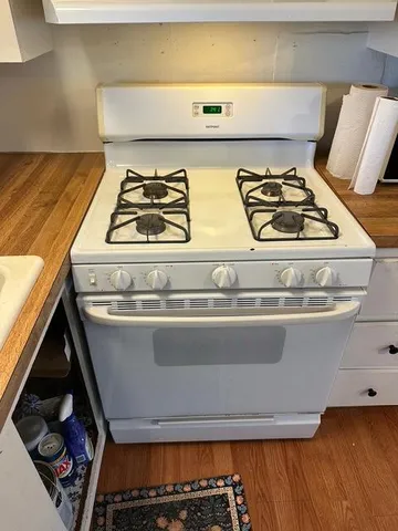 a stove top oven sitting inside of a kitchen