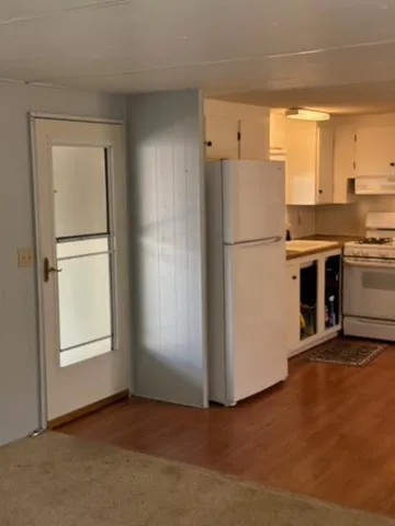 a kitchen with stainless steel appliances a stove a refrigerator and a microwave