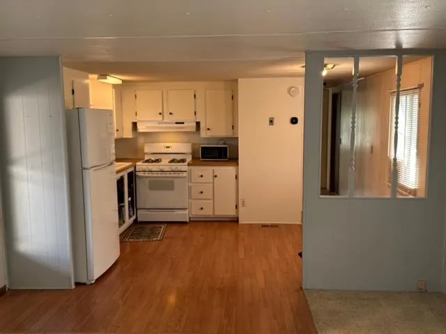 a kitchen with a stove and a wooden cabinets