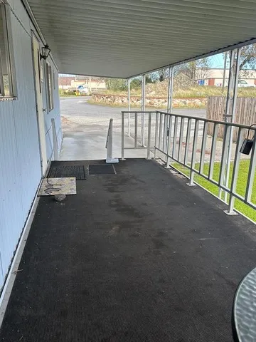 a view of a porch with wooden floor