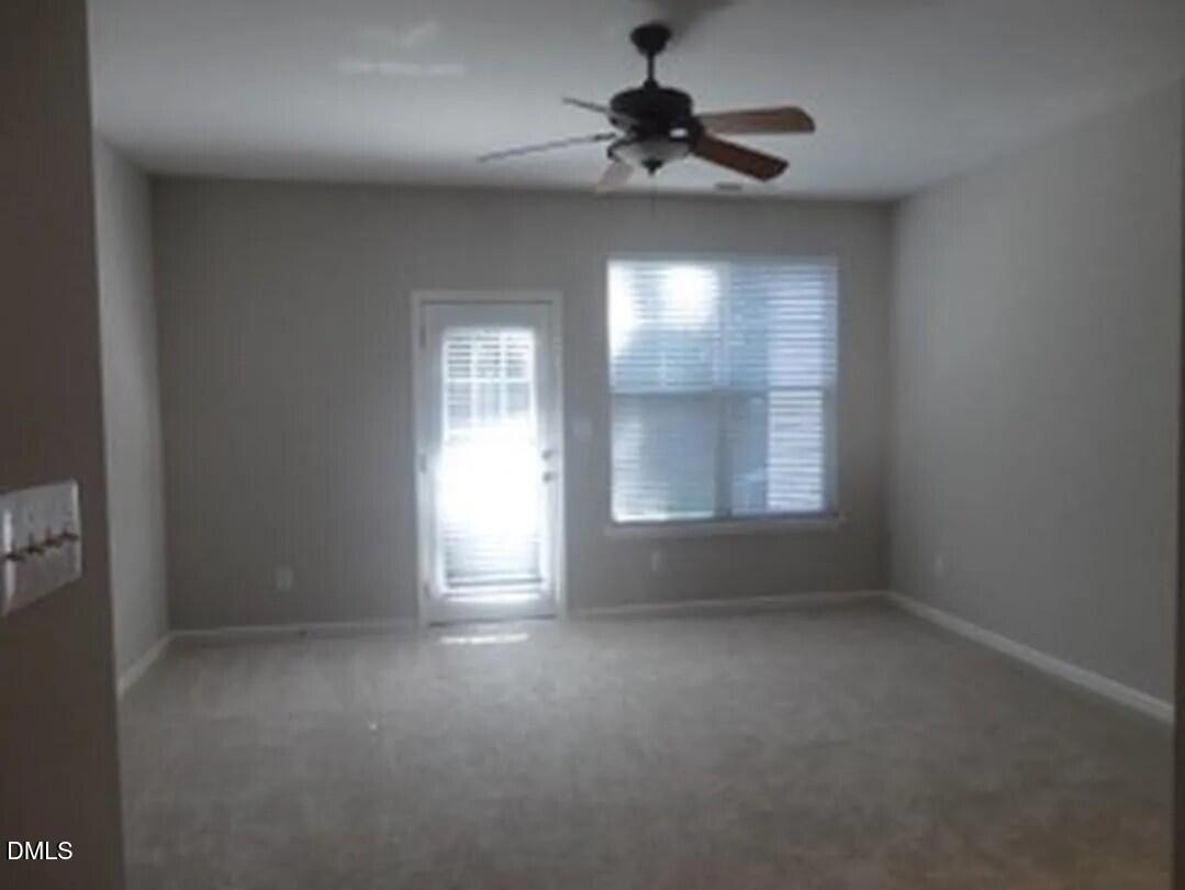 8455 Central Drive Raleigh, NC 27613 - Photo 5 of 7 an empty room with a empty space and windows