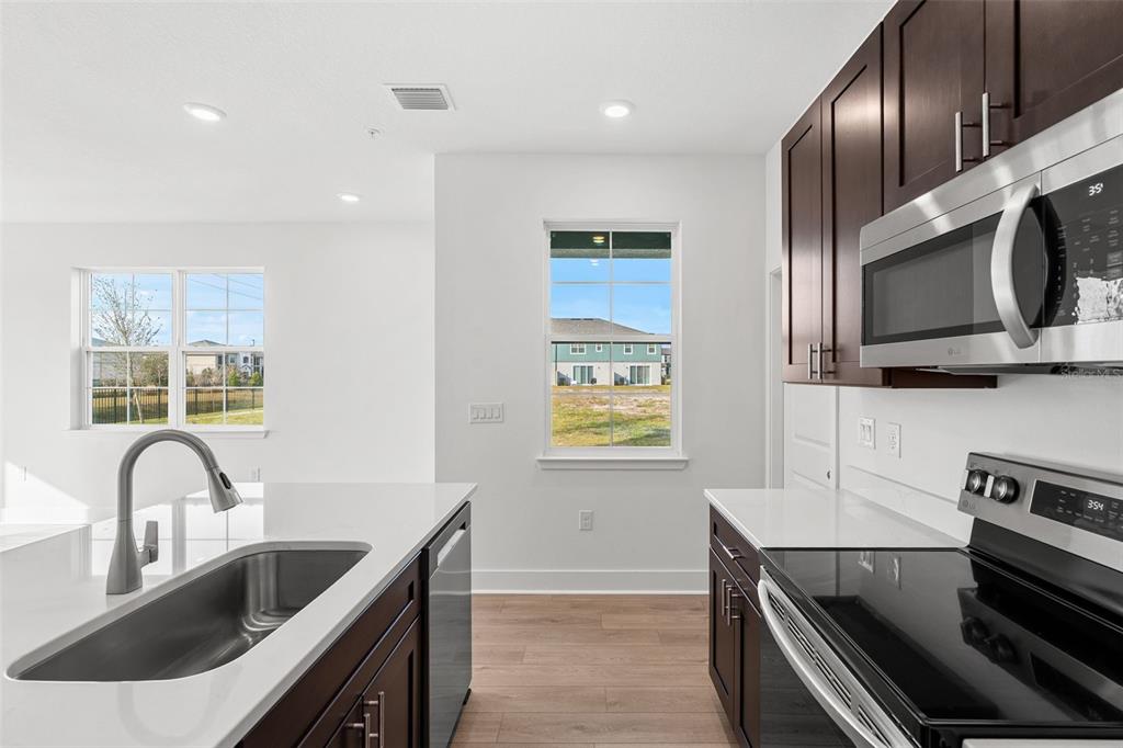 2429 Magnolia Reserve Road Ocoee, FL 34761 - Photo 7 of 14 a kitchen with stainless steel appliances granite countertop a sink and a stove