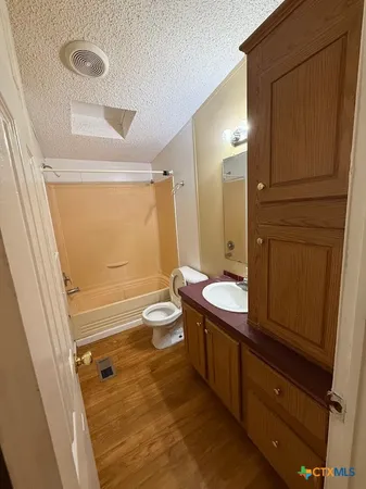 a bathroom with a sink a mirror and a bathtub