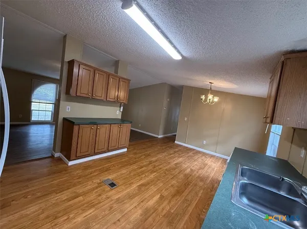 a view of front door and entryway with wooden floor