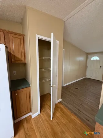 a view of hallway with wooden floor