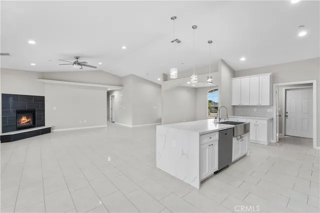 a large white kitchen with a large window