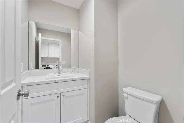 a bathroom with a sink toilet and mirror
