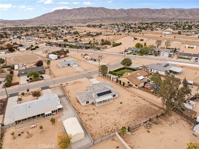 an aerial view of residential house and sandy dunes