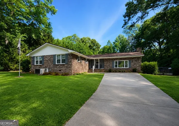 a front view of a house with a garden