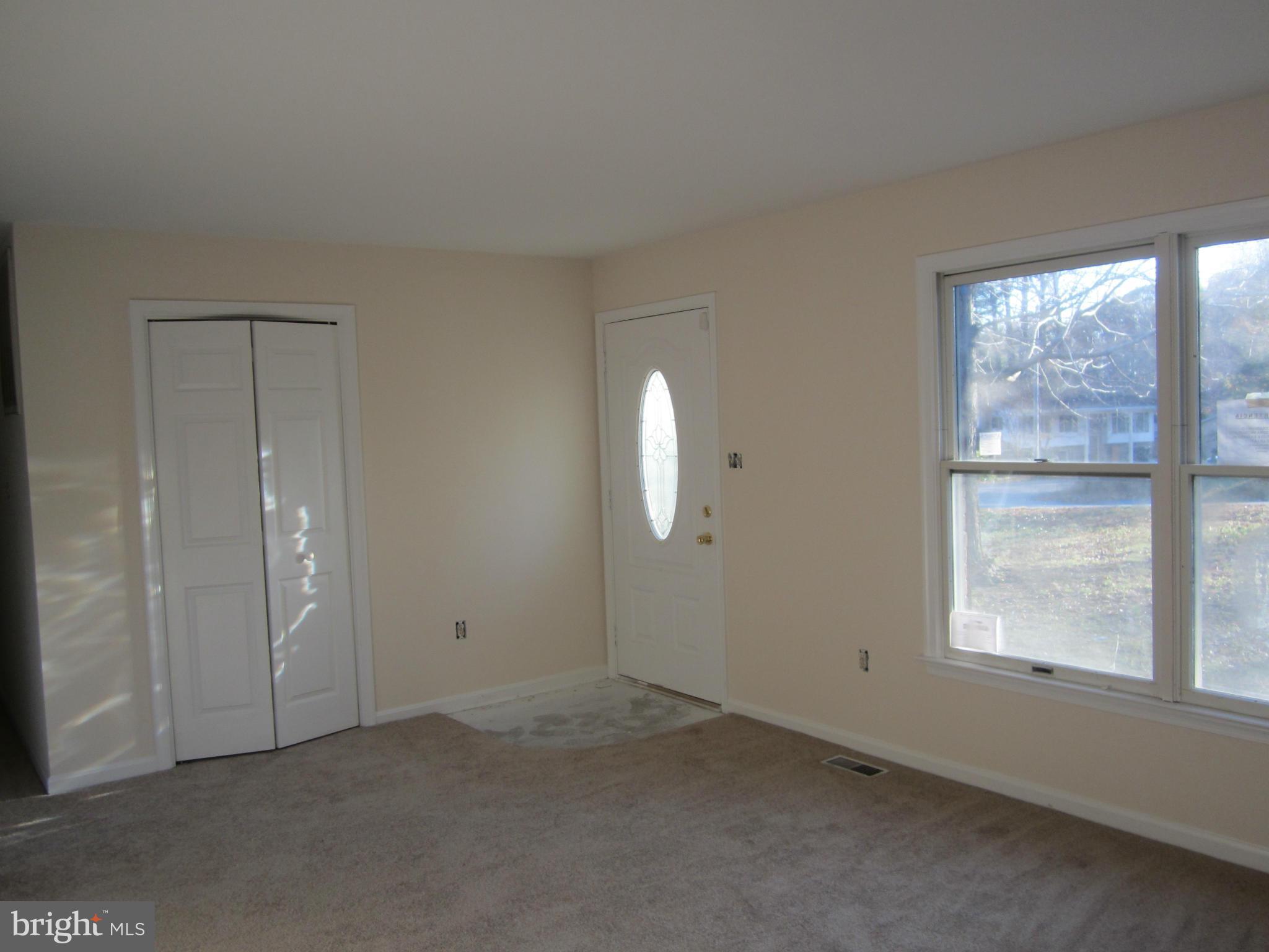 146 Calvert Towne Road Prince Frederick, MD 20678 - Photo 2 of 13 an empty room with windows and closet