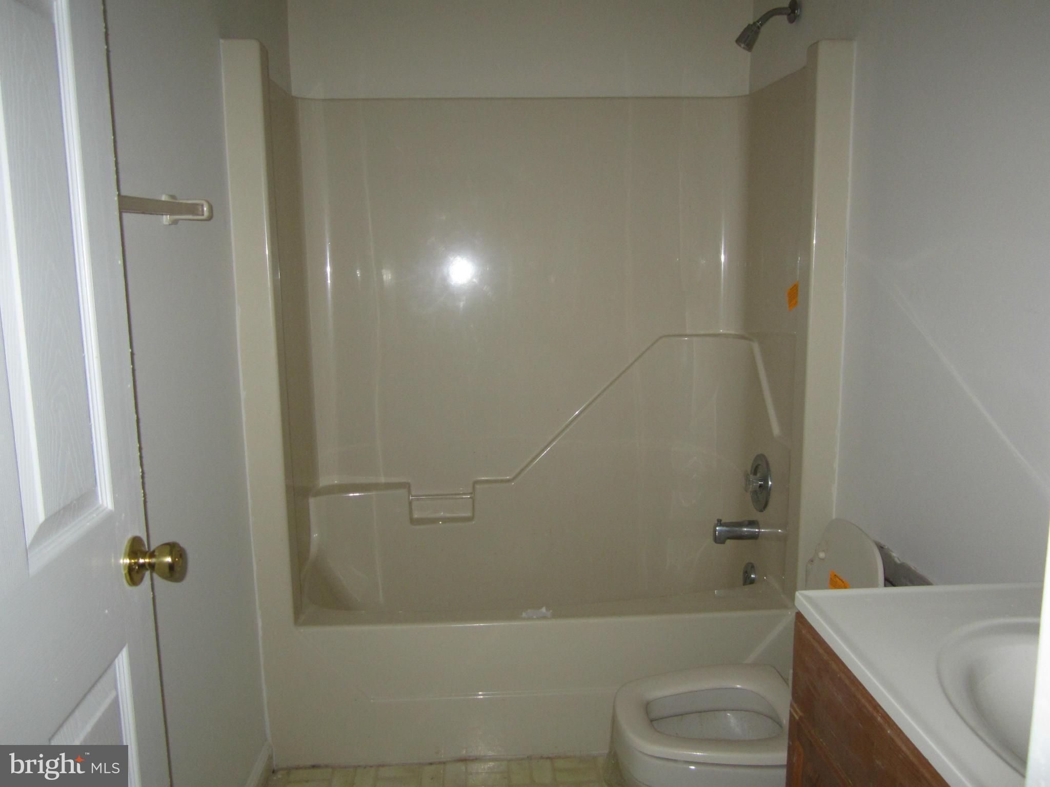 146 Calvert Towne Road Prince Frederick, MD 20678 - Photo 12 of 13 a bathroom with a bathtub and a sink