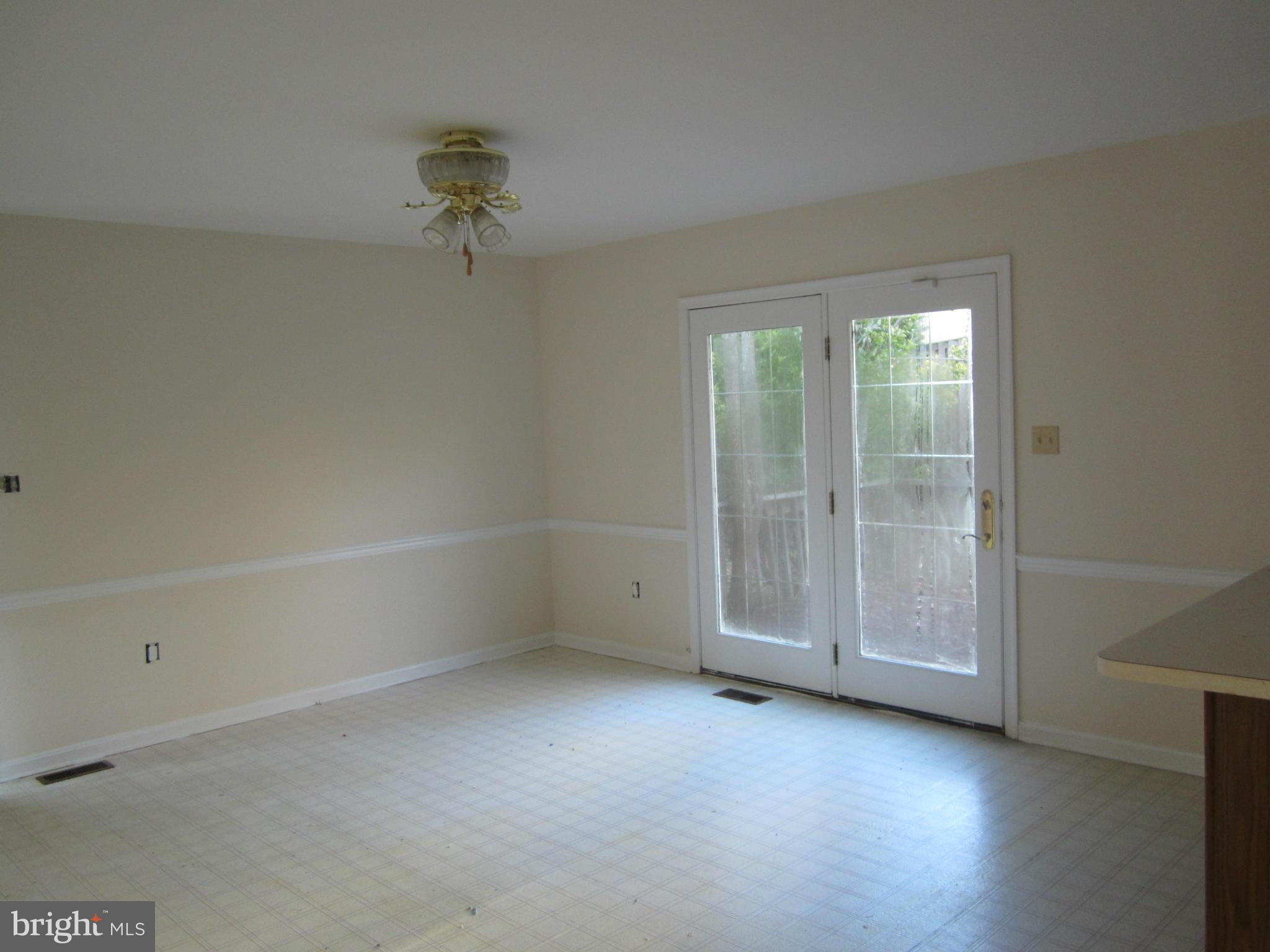 146 Calvert Towne Road Prince Frederick, MD 20678 - Photo 5 of 13 a view of an empty room with a window