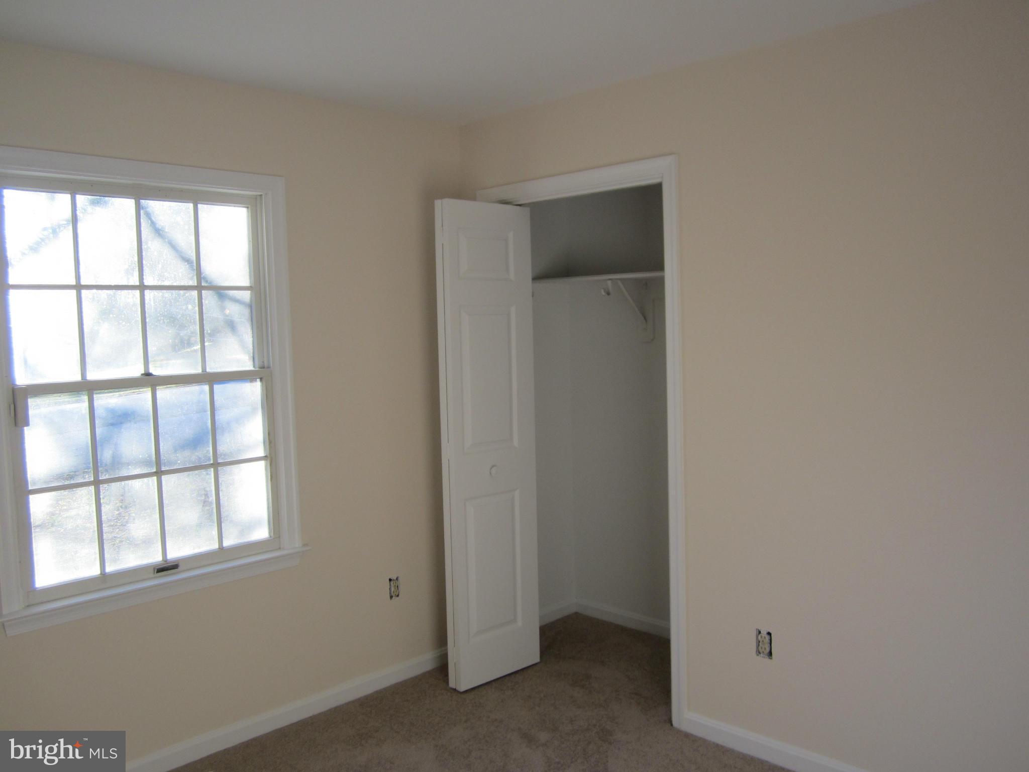 146 Calvert Towne Road Prince Frederick, MD 20678 - Photo 6 of 13 an empty room with windows and closet