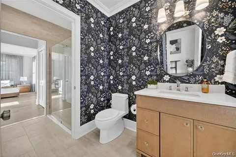 a bathroom with a toilet sink and mirror
