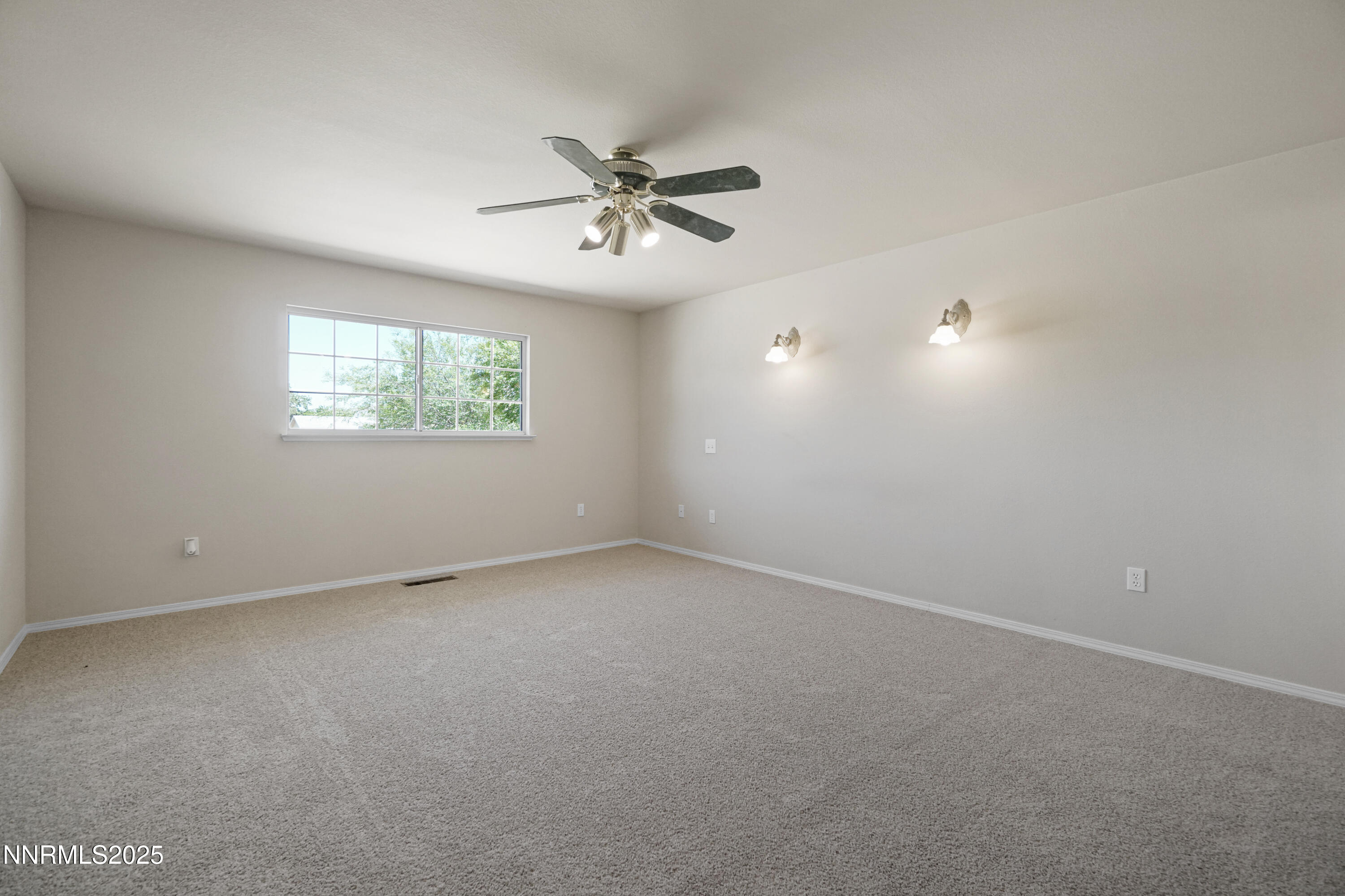 546 Yellow Jacket Road Dayton, NV 89403 - Photo 19 of 25 an empty room with windows and fan