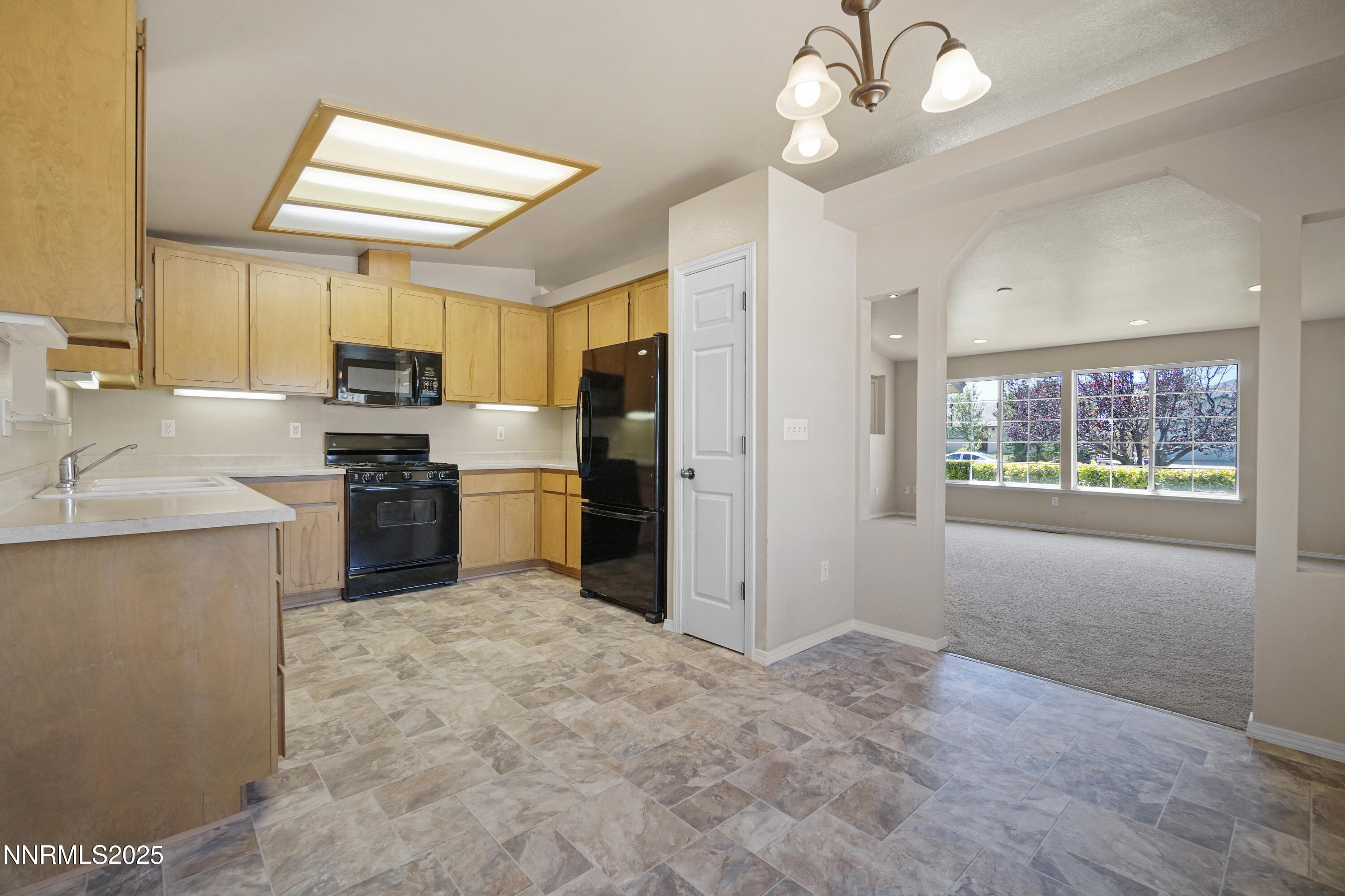 546 Yellow Jacket Road Dayton, NV 89403 - Photo 5 of 25 a kitchen with stainless steel appliances granite countertop a stove refrigerator and cabinets