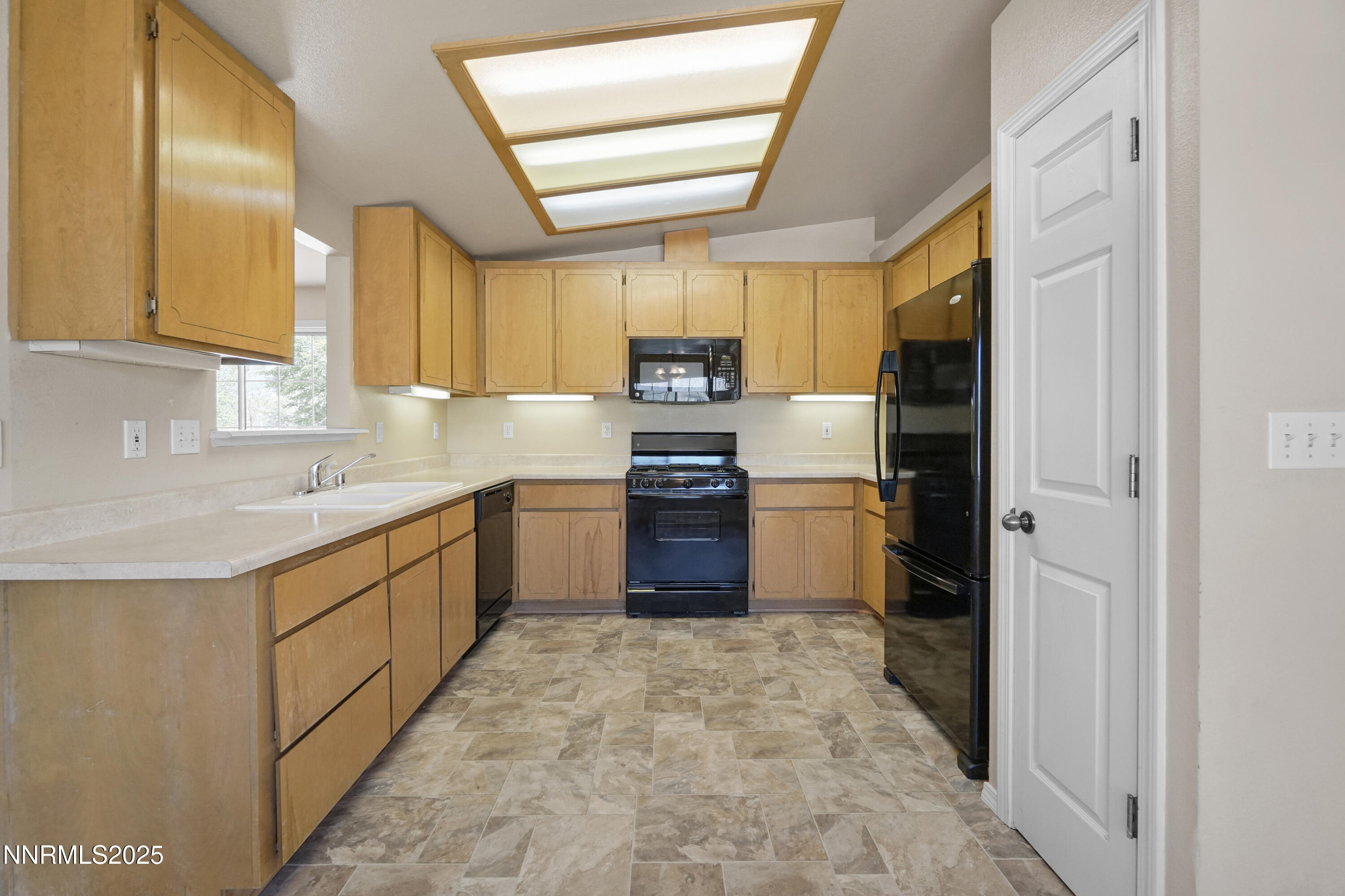 546 Yellow Jacket Road Dayton, NV 89403 - Photo 6 of 25 a kitchen with stainless steel appliances granite countertop a stove a sink and a refrigerator