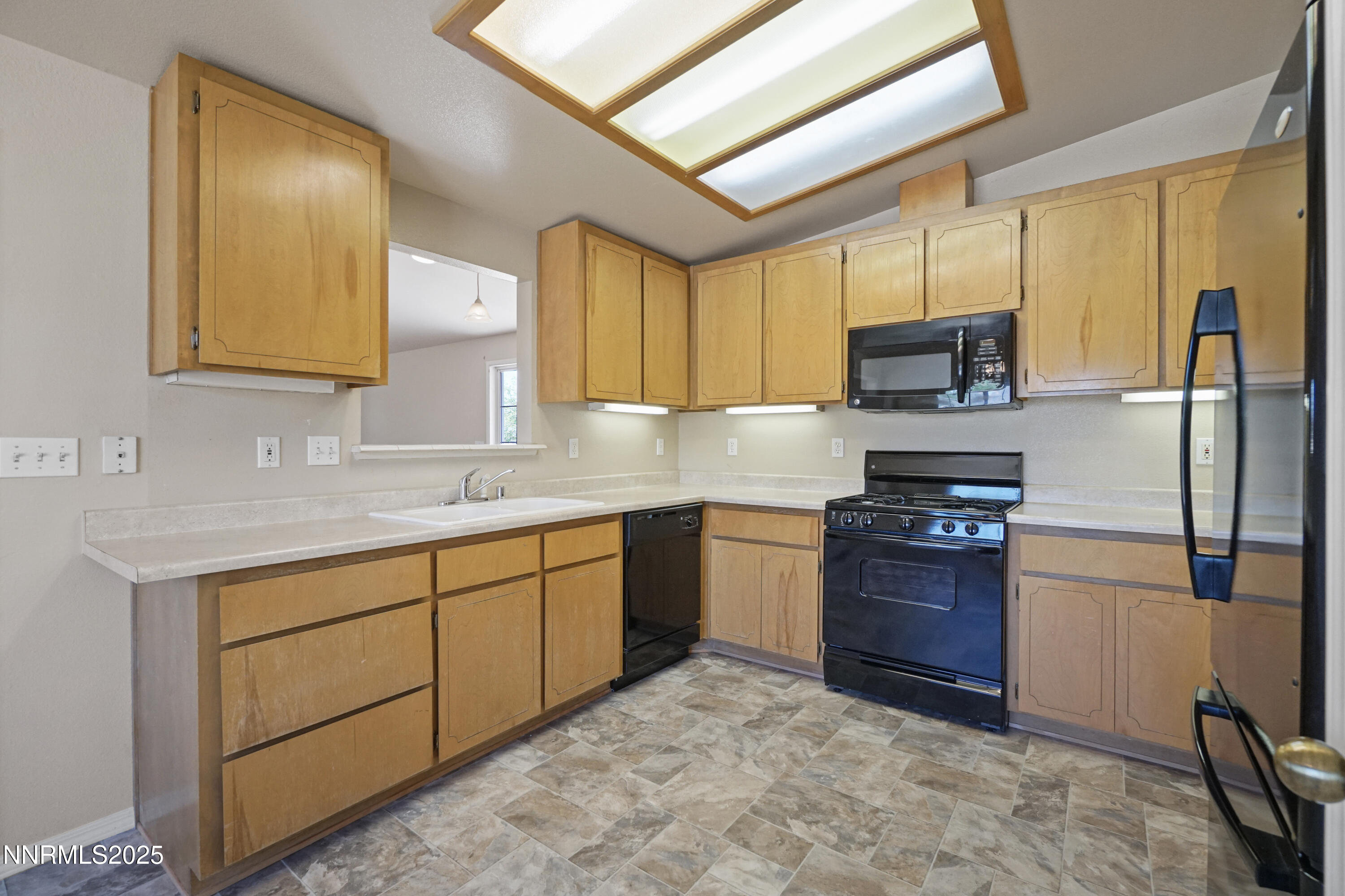 546 Yellow Jacket Road Dayton, NV 89403 - Photo 7 of 25 a kitchen with stainless steel appliances granite countertop a sink refrigerator and microwave