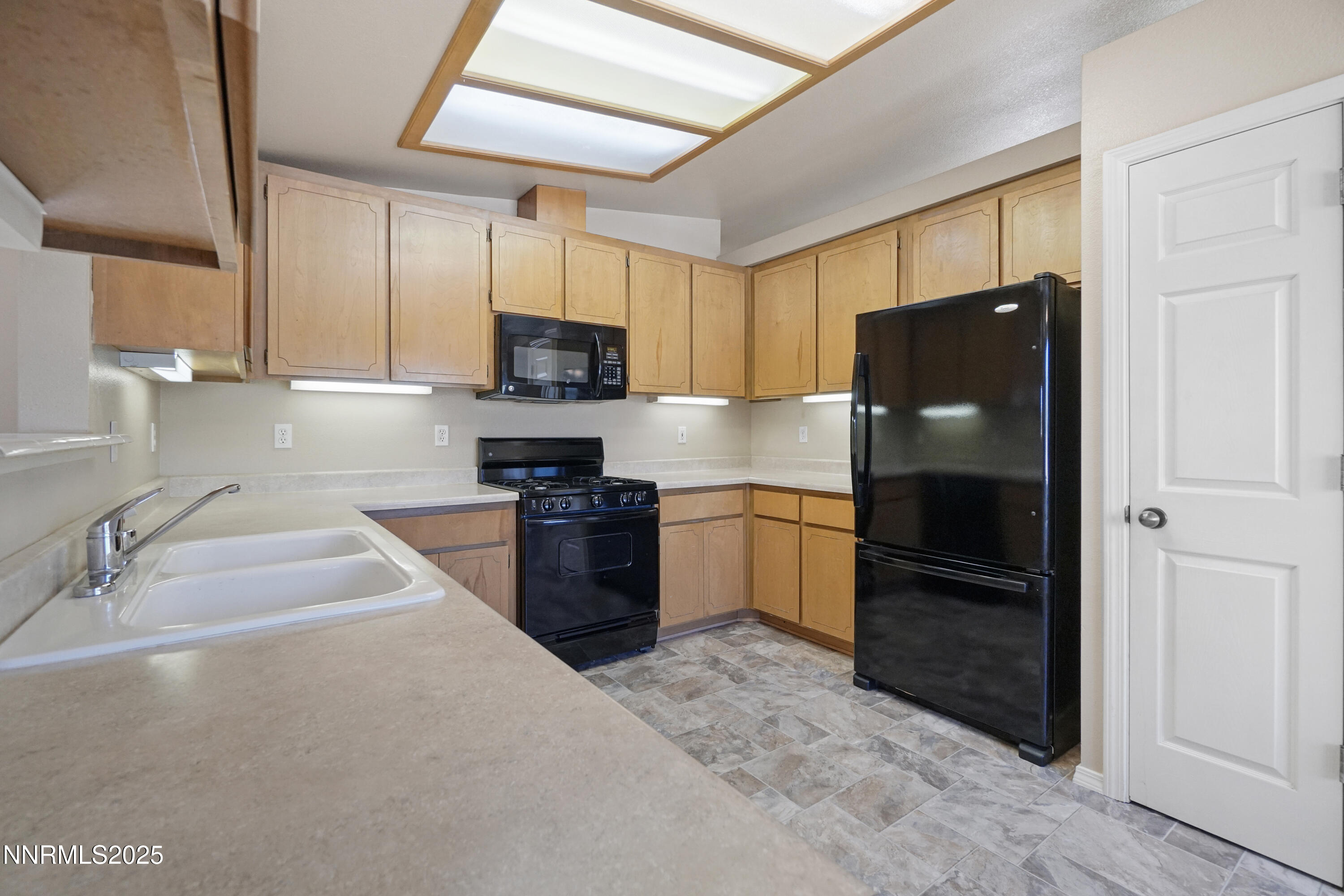 546 Yellow Jacket Road Dayton, NV 89403 - Photo 8 of 25 a kitchen with granite countertop a refrigerator and a sink
