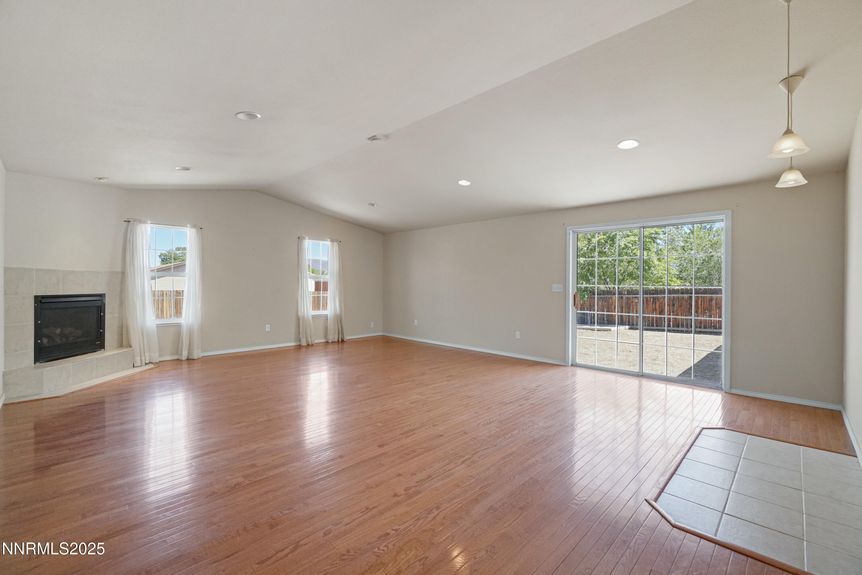 546 Yellow Jacket Road Dayton, NV 89403 - Photo 9 of 25 a view of empty room with wooden floor and fireplace