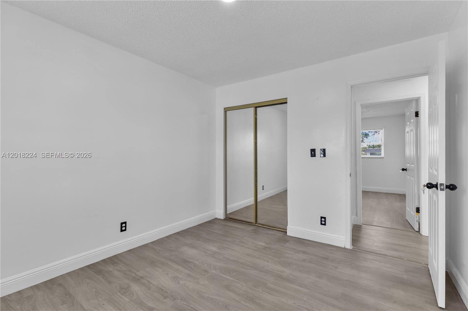 7958 Southwest 6th Street Pompano Beach, FL 33068 - Photo 25 of 57 an empty room with wooden floor