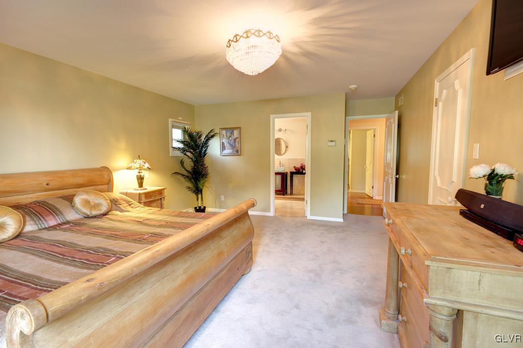 2270 Bishop Road Allentown, PA 18103 - Photo 15 of 33 a large bedroom with a bed and a chandelier