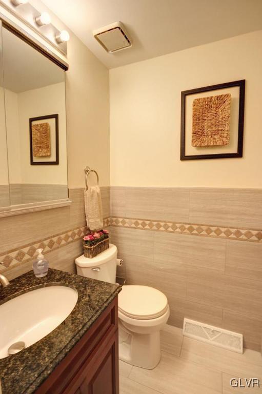 2270 Bishop Road Allentown, PA 18103 - Photo 30 of 33 a bathroom with a granite countertop sink mirror vanity and toilet