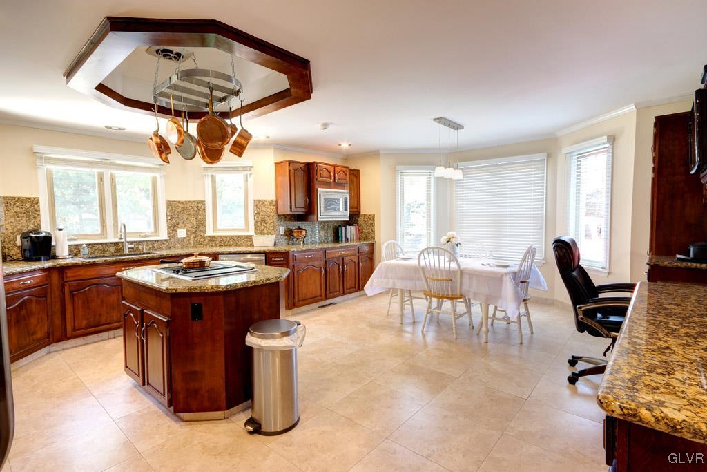 2270 Bishop Road Allentown, PA 18103 - Photo 10 of 33 a kitchen with a stove kitchen island wooden cabinets and stainless steel appliances