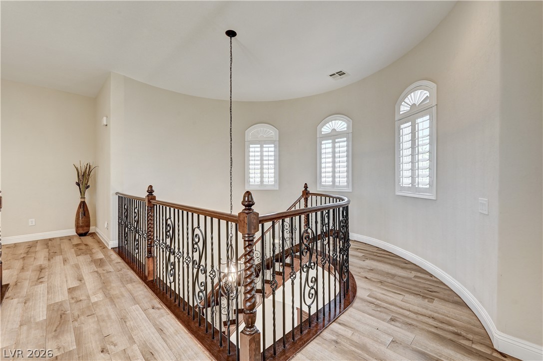 2793 Rosenhearty Drive Henderson, NV 89044 - Photo 35 of 77 Elegant wrought iron and wood bannister leads to the naturally illuminated upper level with decorative arched windows.
