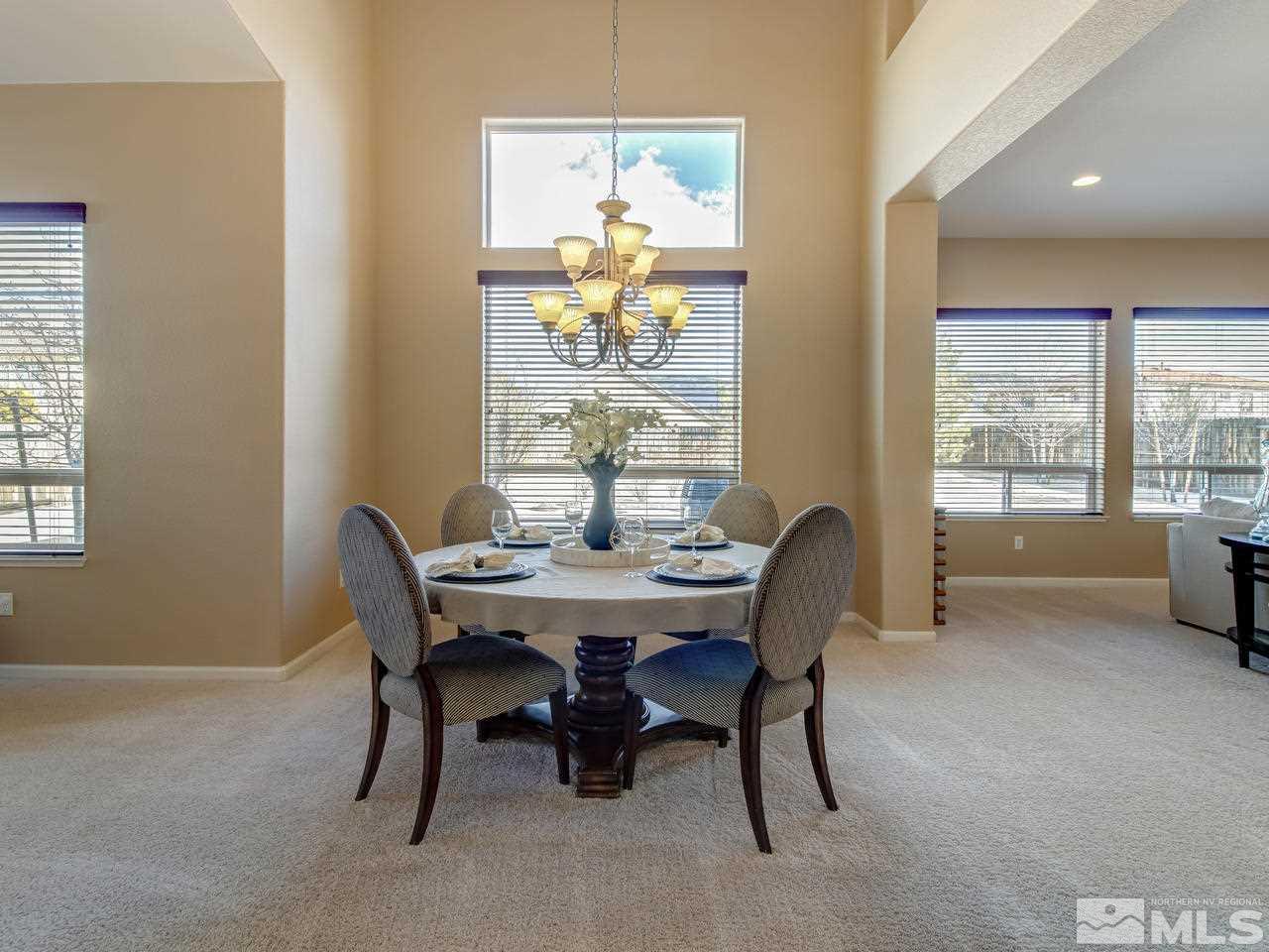 10520 Kenai Drive Reno, NV 89521 - Photo 6 of 25 a dining room with furniture a rug and a chandelier