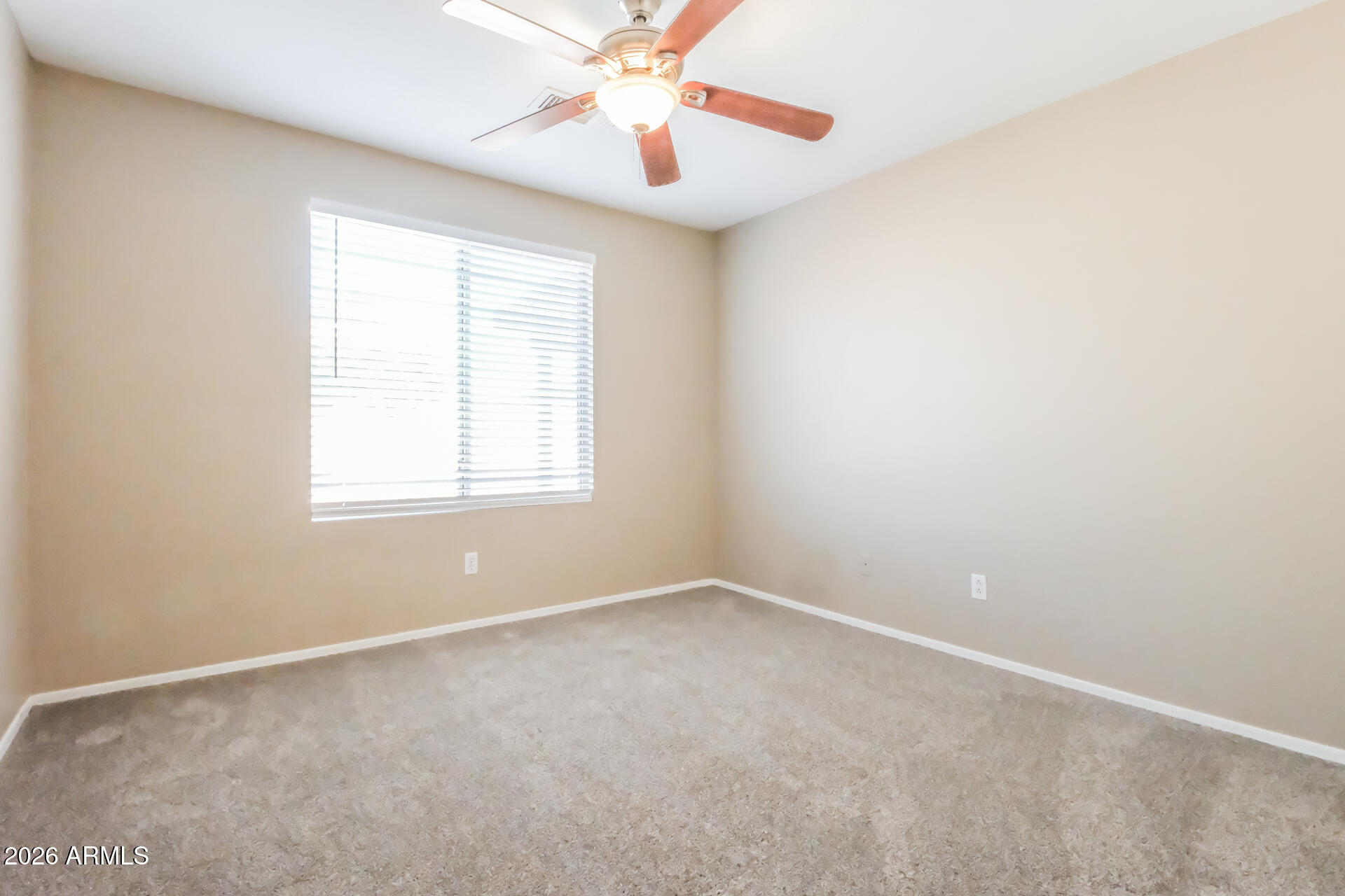 1108 West 13th Avenue Apache Junction, AZ 85120 - Photo 17 of 21 an empty room with windows and fan