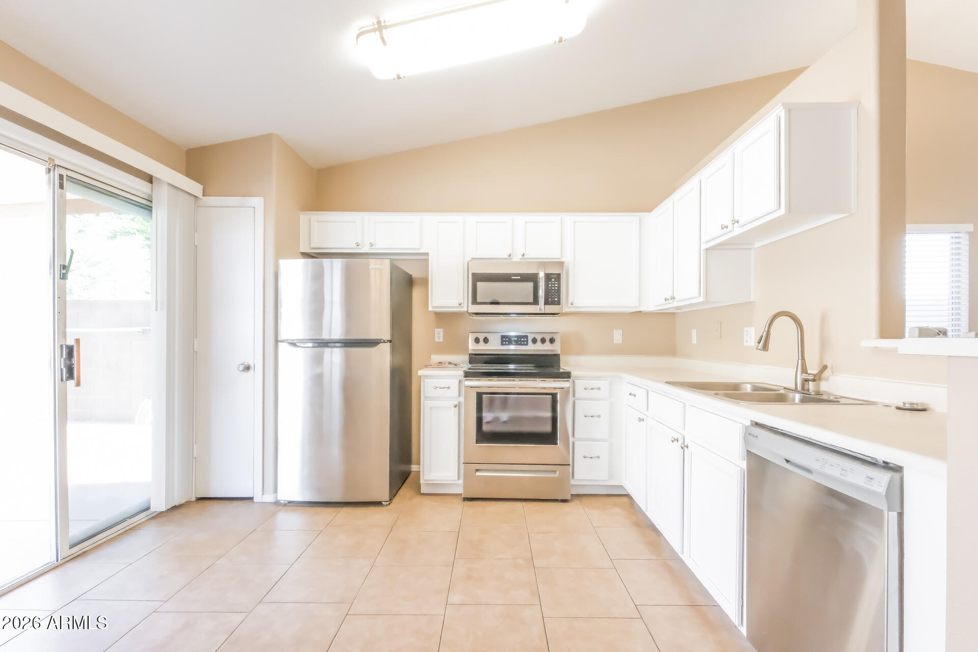 1108 West 13th Avenue Apache Junction, AZ 85120 - Photo 6 of 21 a kitchen with stainless steel appliances granite countertop a refrigerator and a sink