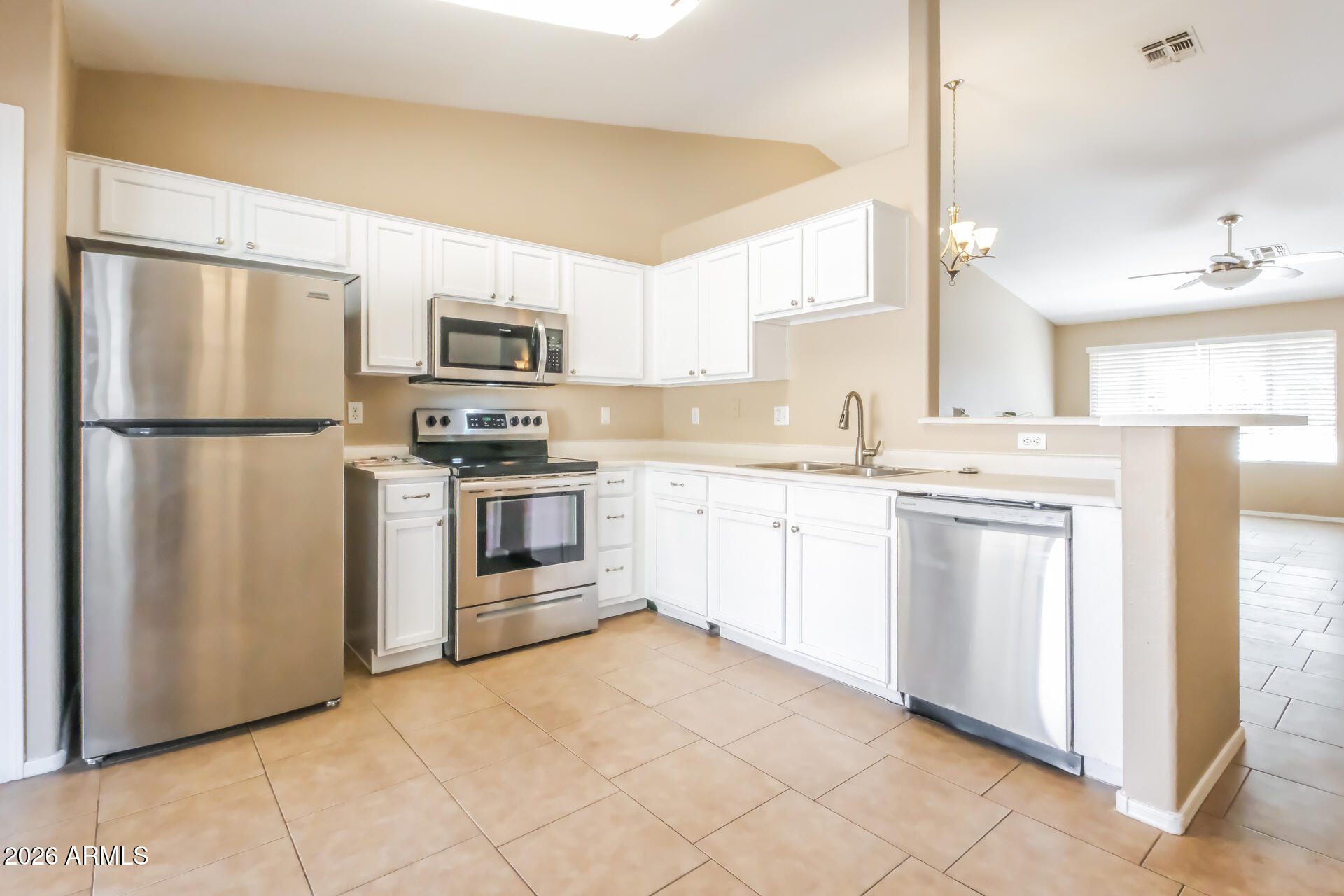 1108 West 13th Avenue Apache Junction, AZ 85120 - Photo 7 of 21 a kitchen with white cabinets and white appliances