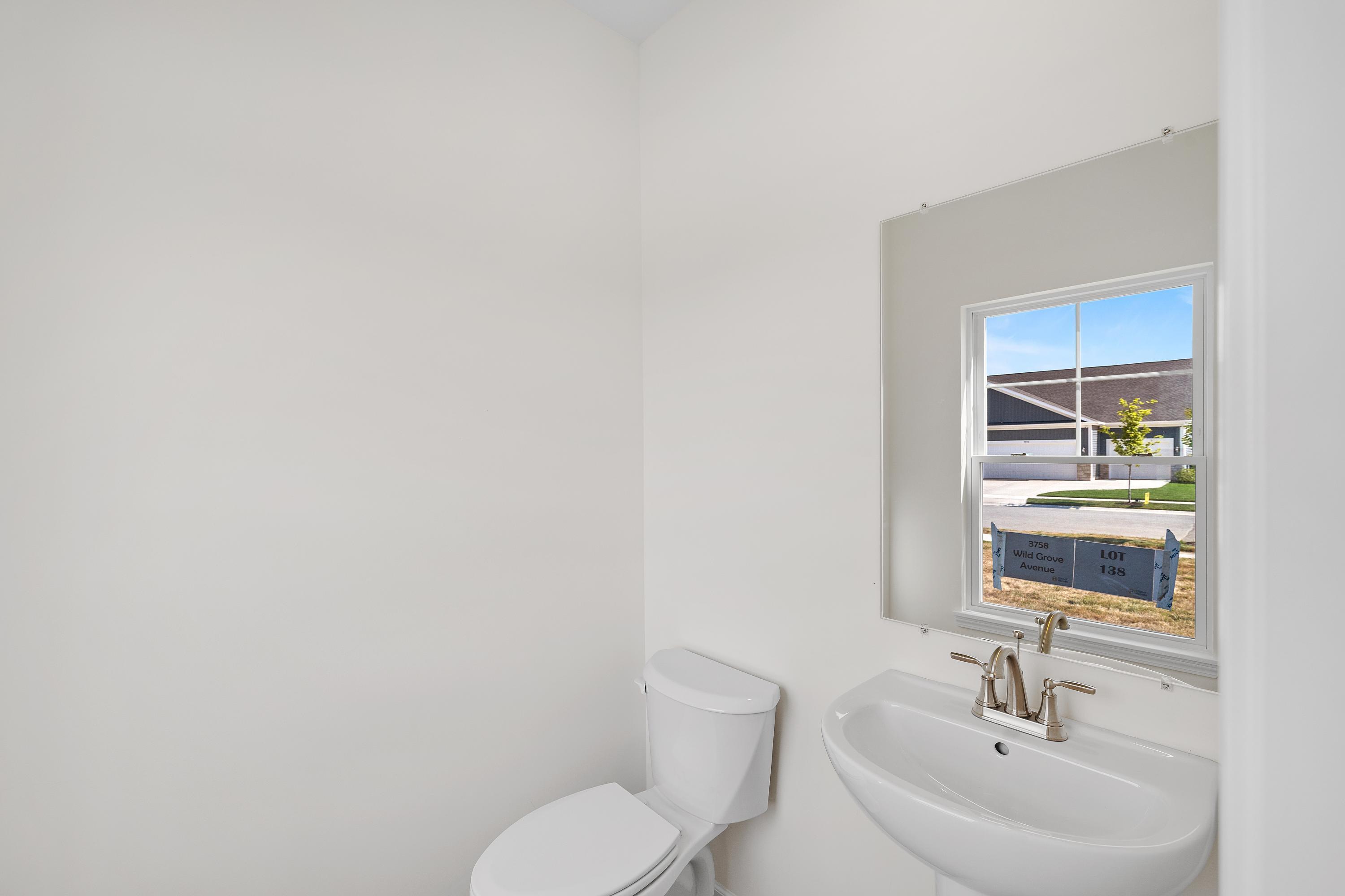 3758 Wild Grove Way Valparaiso, IN 46385 - Photo 11 of 19 a bathroom with a toilet a sink and mirror
