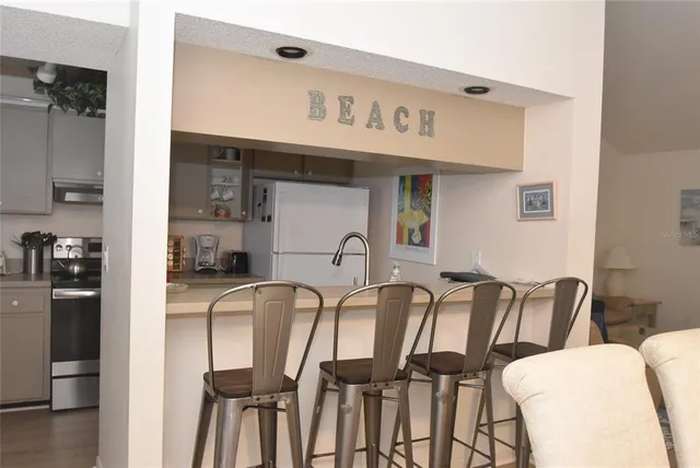 a kitchen with granite countertop a sink a stove and cabinets