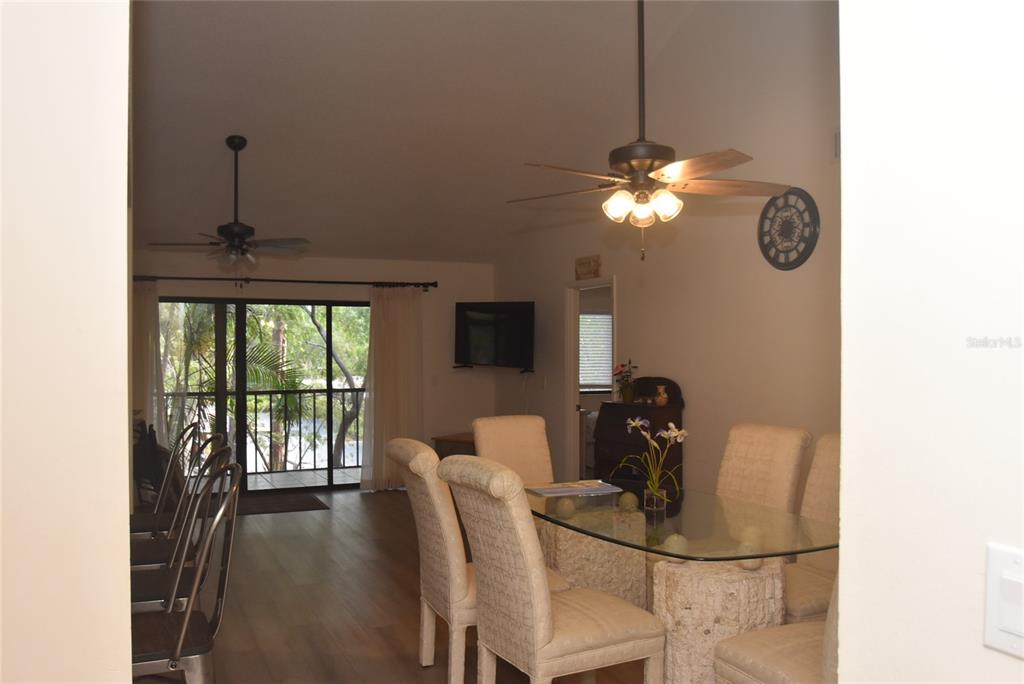 1712 Glenhouse Drive, Unit GL418 Sarasota, FL 34231 - Photo 33 of 37 a dining room with furniture and chandelier fan