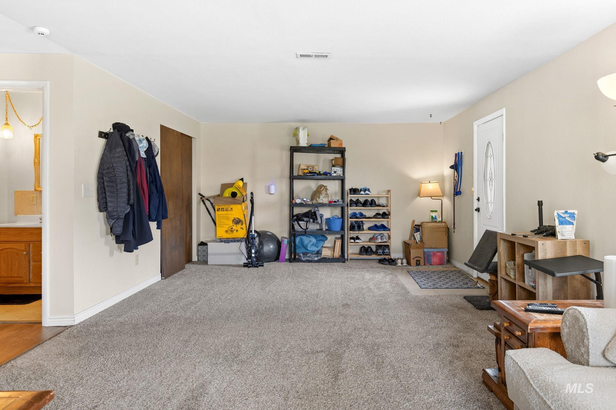 18338 Pride Lane Caldwell, ID 83607 - Photo 6 of 50 Spacious living area featuring neutral carpeting and light-toned walls