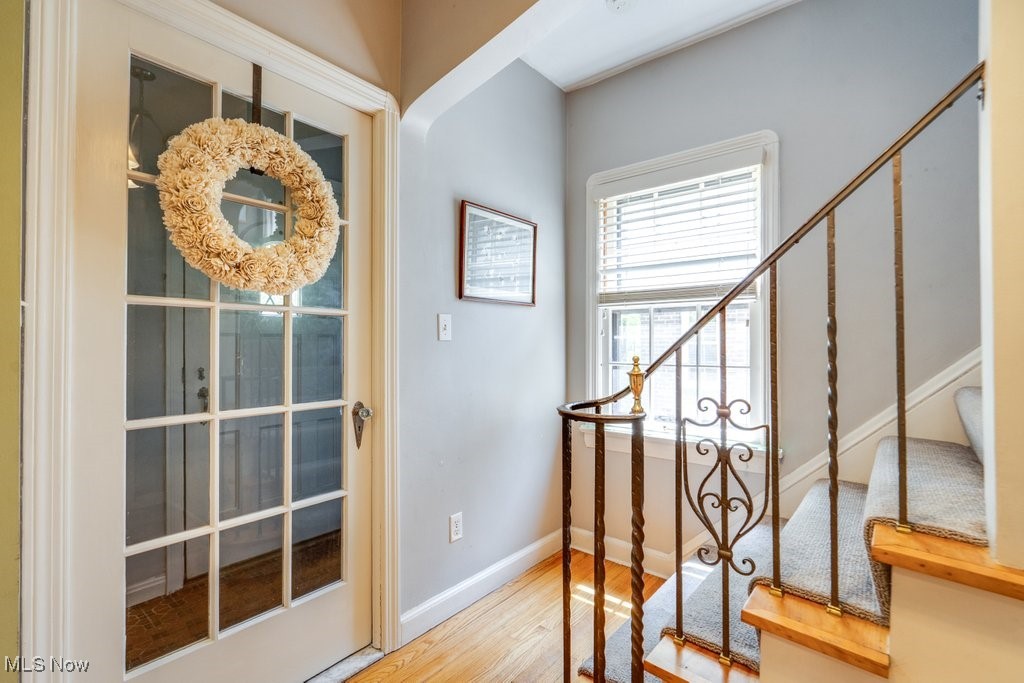 2500 Eaton Road Cleveland, OH 44118 - Photo 10 of 50 Foyer featuring wood floors, stairs, and baseboards