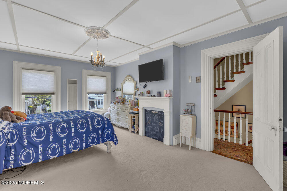 75 Elizabeth Street Keyport, NJ 07735 - Photo 28 of 61 a spacious bedroom with a bed dresser and a flat screen tv