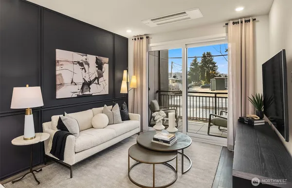 a living room with furniture a flat screen tv and a window