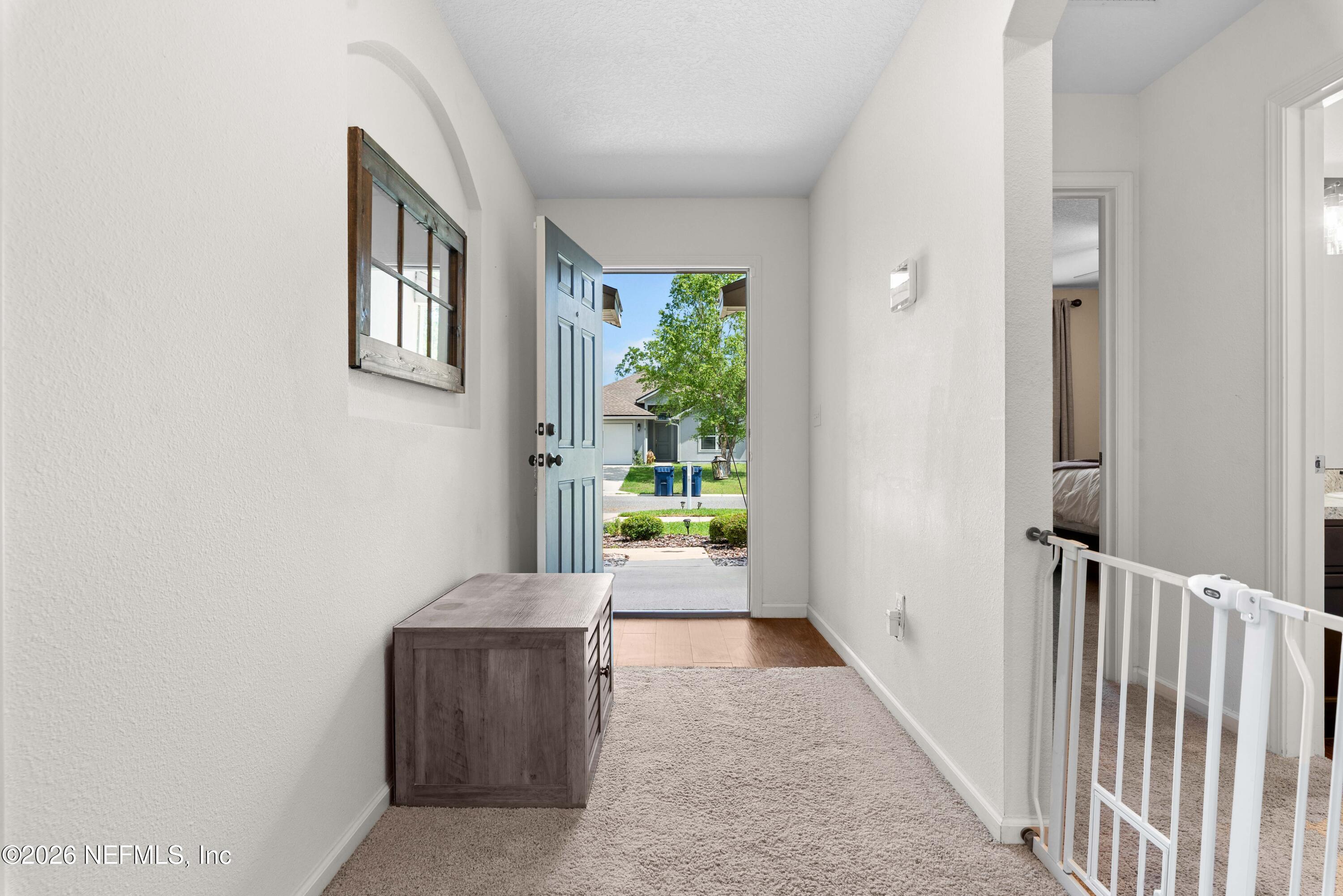 6178 Daylilly Road Macclenny, FL 32063 - Photo 5 of 29 a view of hallway with windows and flower pot