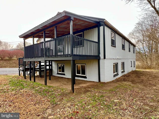 a view of a house with a wooden deck